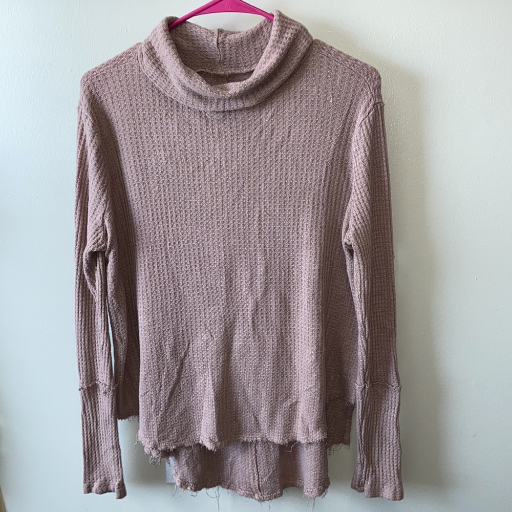 Distressed turtleneck sweater.
